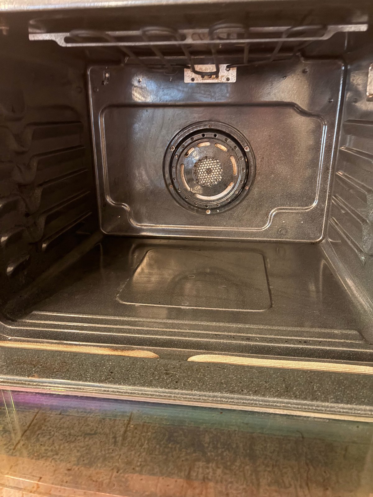 Interior view of a microwave oven showing the turntable and heating element centered in the chamber